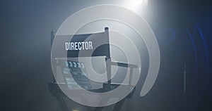 Chair of director with clapboard in spotlight photo