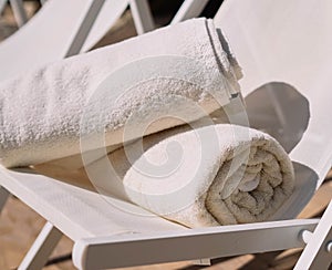 Hotel pool chair with folded towels photo