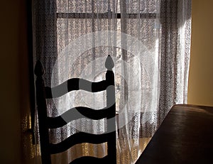 Chair and lace curtains, window light