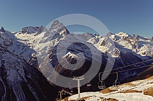 Chair lift and Belalakaya peak. The main Caucasian ridge. Dombai, Karachay-Cherkessia, Russia