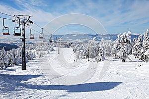 Chair lift on mountain for downhill skiers