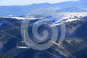 Chair lift on mountains background
