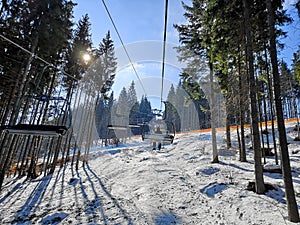 Chair lift with skier at ski resort