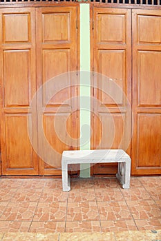 Chair near wooden wall