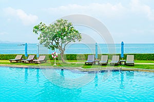 chair pool and umbrella around swimming pool