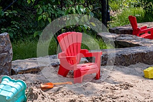 Chair and sand toys in sand box