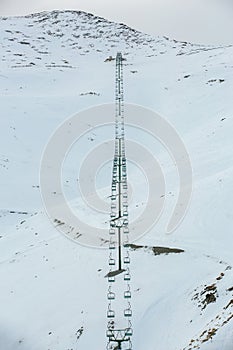 Chair ski lift in South island, New zealand with snow covered the mountains