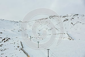 Chair ski lift in South island, New zealand with snow covered the mountains