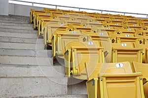A chair for watching sports on the amphitheater. Chairs lined up in the stands.