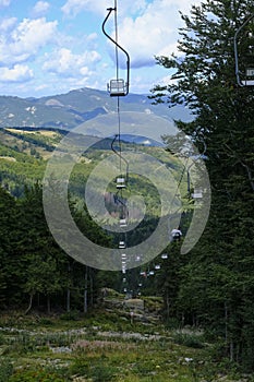 Chairlift across the mountains and cloudy sky. National park Appennino Tosco-Emiliano. Lagdei, Emilia-Romagna photo