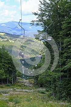 Chairlift across the mountains and cloudy sky. National park Appennino Tosco-Emiliano. Lagdei, Emilia-Romagna photo