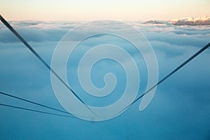 Chairlift cabin in a ski resort among snow-capped mountains in the fog photo