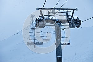 Chairlift with high metal poles to climb skiers to the top of the mountain, Grandvalira, Andorra,