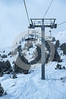 Chairlift with high metal poles to climb skiers to the top of the mountain, Grandvalira, Andorra,