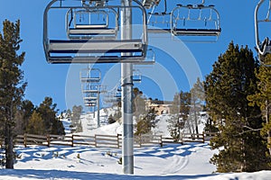 Chairlift line at a winter resort in the mountains.