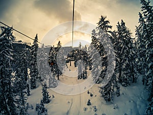 Chairlift on Mount Faloria after a snowfall at sunset, Cortina D photo