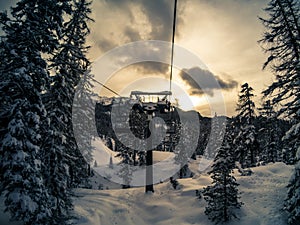 Chairlift on Mount Faloria after a snowfall at sunset, Cortina D photo