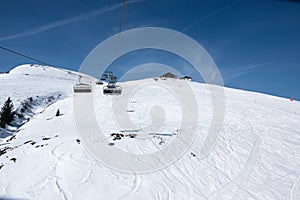 Chairlift and ski slope in winter in the Alps.