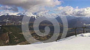 Chairlift and ski slopes with the Marsicani mountain range in the background.