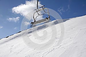 A chairlift on a snow-capped mountain peak.