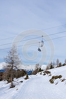 Chairlifts in winter with undefined skiers in ski resort