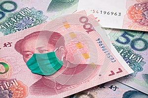 Chairman Mao wear face mask on Chinese renminbi yuan banknote background. Global novel coronavirus Covid-19 outbreak