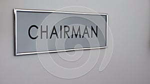 Chairman office door, hand knocking closeup, negotiation room, work conference