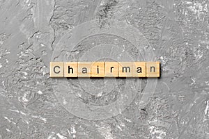 CHAIRMAN word written on wood block. CHAIRMAN text on cement table for your desing, concept