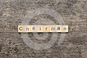 CHAIRMAN word written on wood block. CHAIRMAN text on cement table for your desing, concept