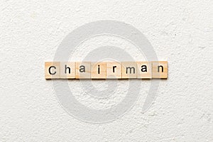 CHAIRMAN word written on wood block. CHAIRMAN text on cement table for your desing, concept