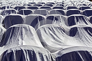 Chairs in the auditorium, covered with a white cloth to protect from dust and dirt