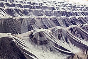 Chairs in the auditorium, covered with a white cloth to protect from dust and dirt