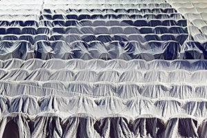 Chairs in the auditorium, covered with a white cloth to protect from dust and dirt