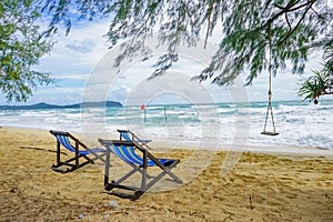 2 chairs on the beach for relaxing.