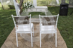Chairs for bride and groom at altar photo