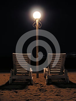 Chairs on night beach