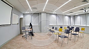 Chairs with notepads in an empty classroom