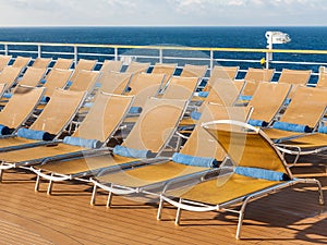 Chairs on outdoor deck on stern of cruise liner