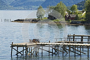 Chairs at the pier of a fjord in Balestrand, Norway. photo
