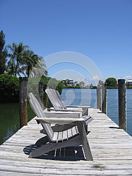 Chairs on a river boardwalk