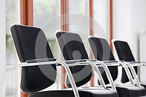 Chairs in a row in a sunny waiting room or lounge