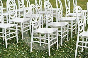 Chairs set up by the green lawn in preparation for a wedding reception