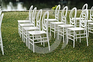 Chairs set up by the green lawn in preparation for a wedding reception