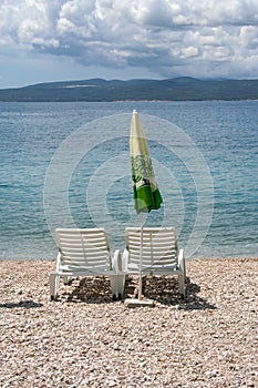 Chairs and sunny umbrella on the beach