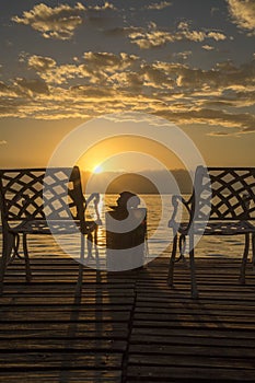 Chairs at sunrise on the sea beach