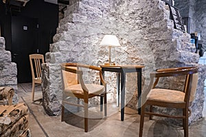 Chairs and table arranged against wall in beautiful luxurious hotel lobby