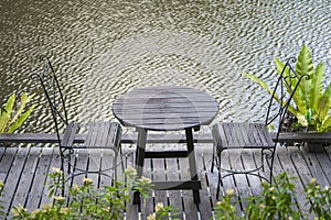 Chairs and table on the backyard in tropical garden near lake with beautiful view in island Borneo, Malaysia