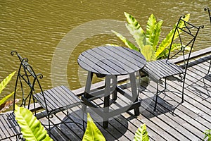 Chairs and table on the backyard in tropical garden near lake with beautiful view in island Borneo, Malaysia