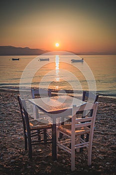 Chairs and table on the beach, Greece