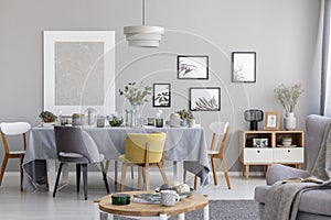 Chairs at table with grey cloth in modern dining room